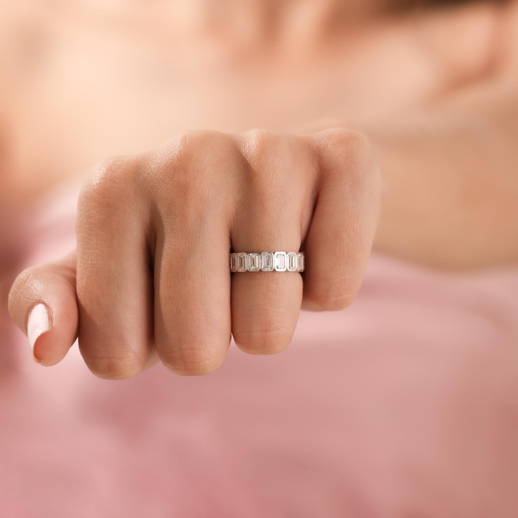 Front view of white gold Emerald Cut Wedding Band on hand, showcasing its modern elegance and full eternity diamond setting.