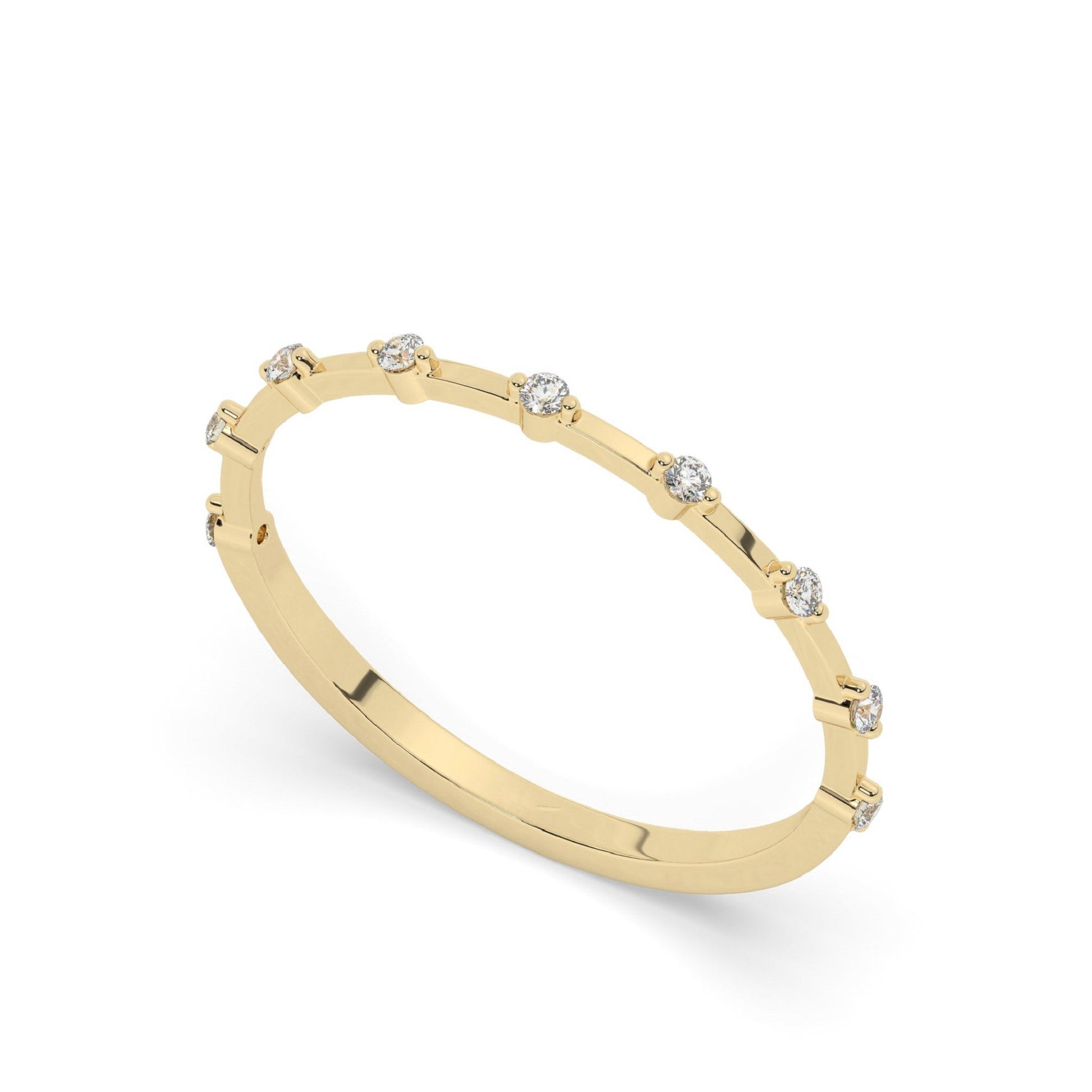 Minimalist yellow gold diamond wedding ring featuring round pavé-set lab diamonds in a spaced design, perfect for modern bridal jewelry collections.