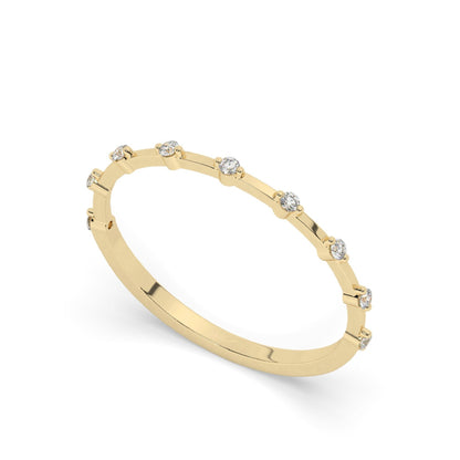 Minimalist yellow gold diamond wedding ring featuring round pavé-set lab diamonds in a spaced design, perfect for modern bridal jewelry collections.