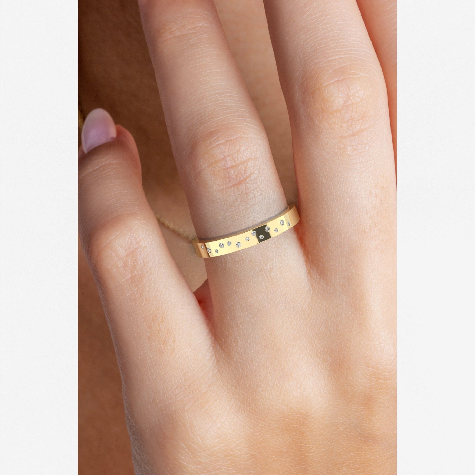 Yellow gold Flush Set Diamond Wedding Band worn on hand, showing scattered lab diamonds and sleek profile. Ideal for modern bridal jewelry styling.