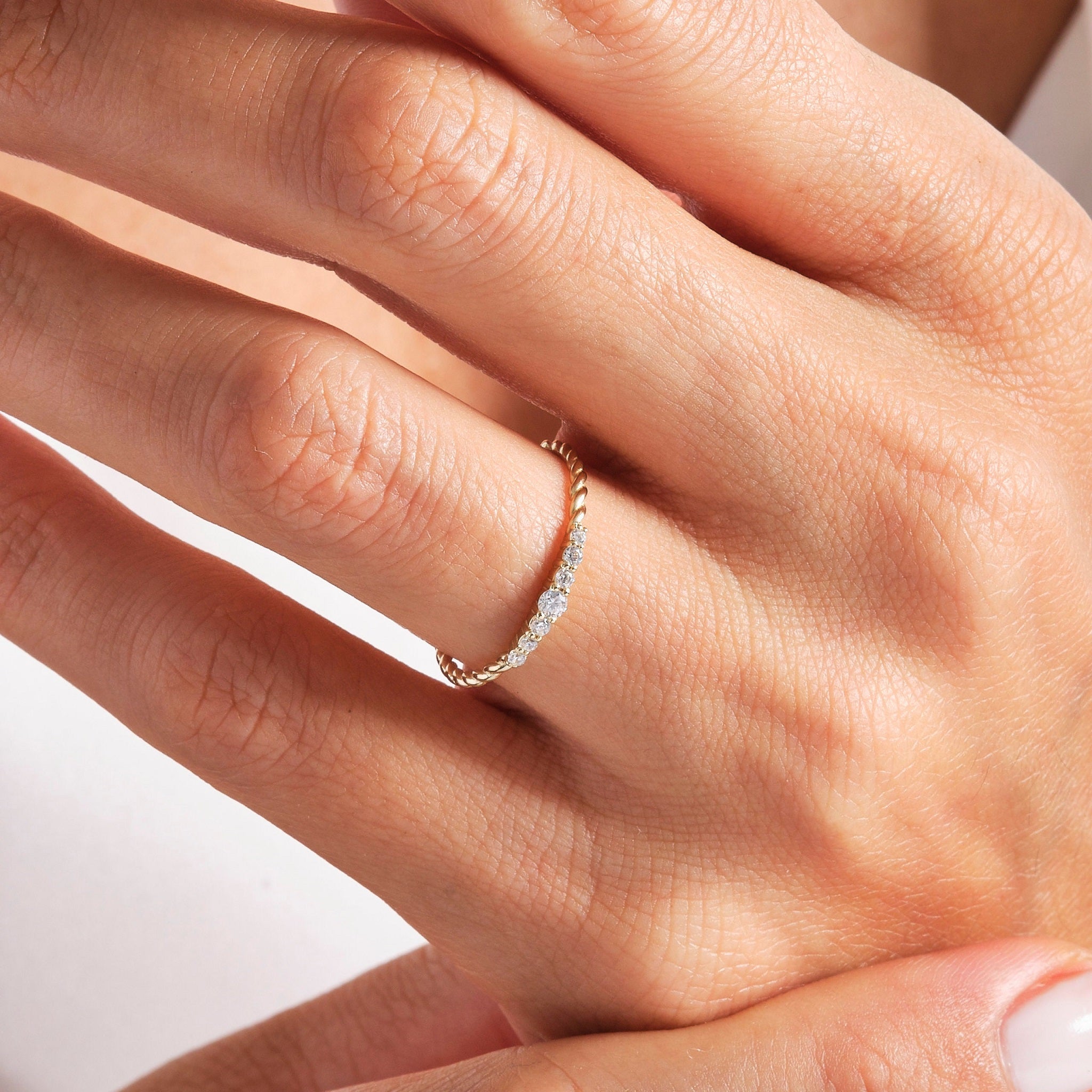 Close-up of yellow gold Diamond Wedding Ring - Lab Diamonds | Carat Rio worn on finger, showing twisted rope and diamond detail.