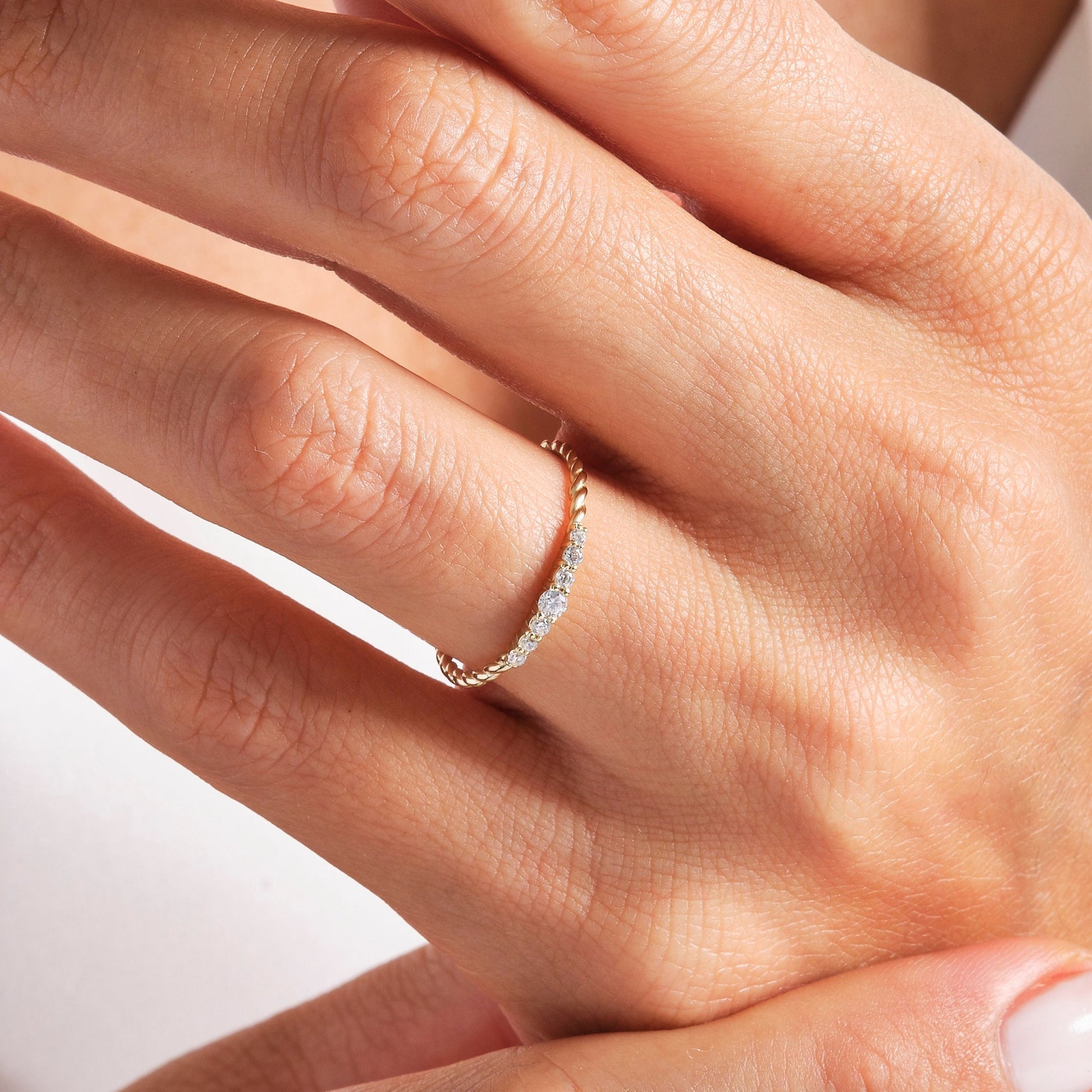 Close-up of yellow gold Diamond Wedding Ring - Lab Diamonds | Carat Rio worn on finger, showing twisted rope and diamond detail.